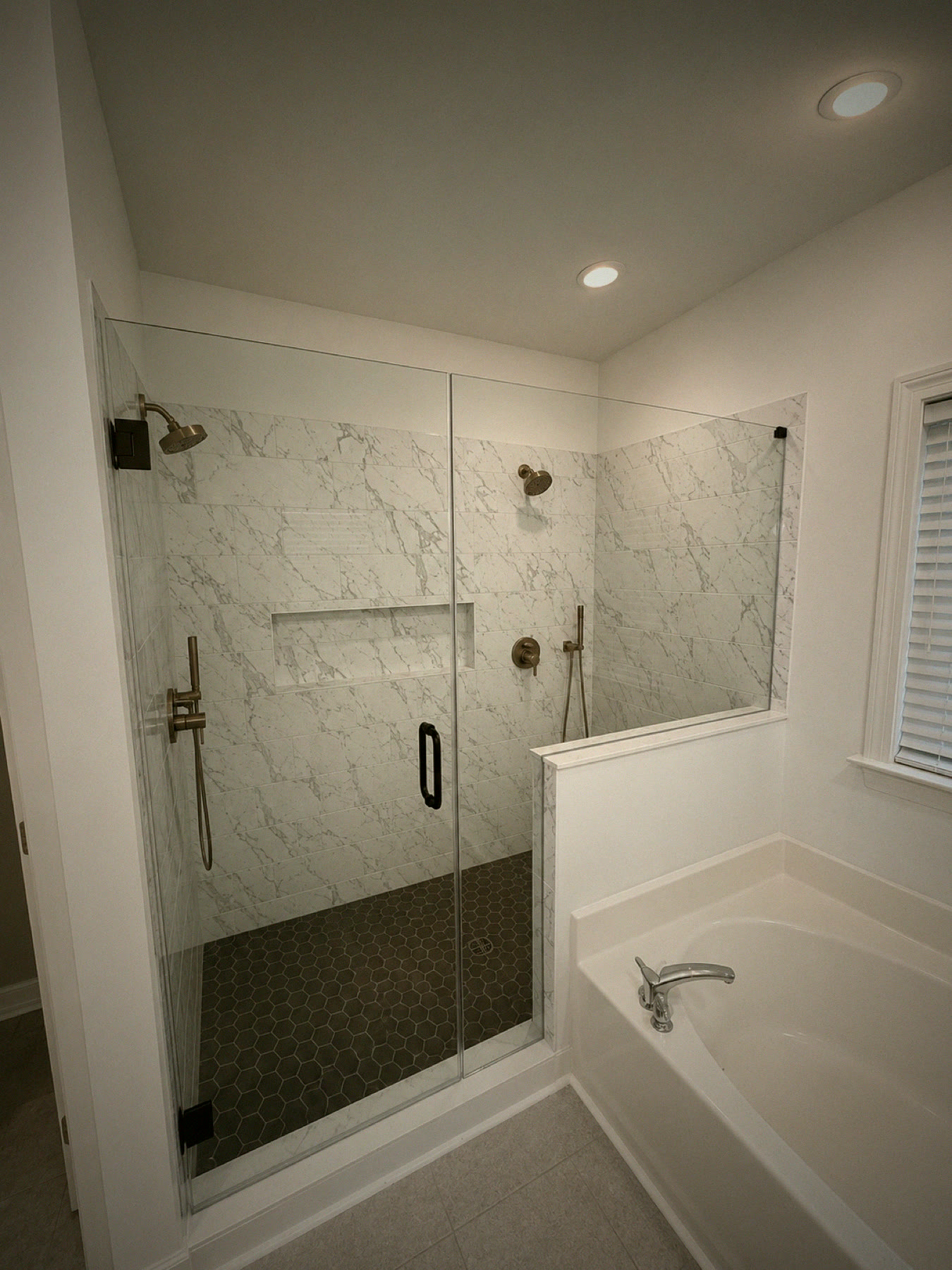 Finished master bathroom remodel with marble tile shower