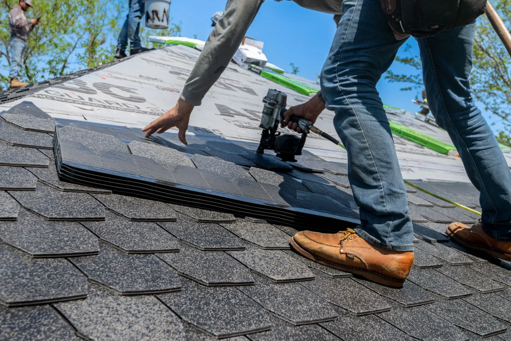 Roofing crew installing new asphalt shingles on an Atlanta home
