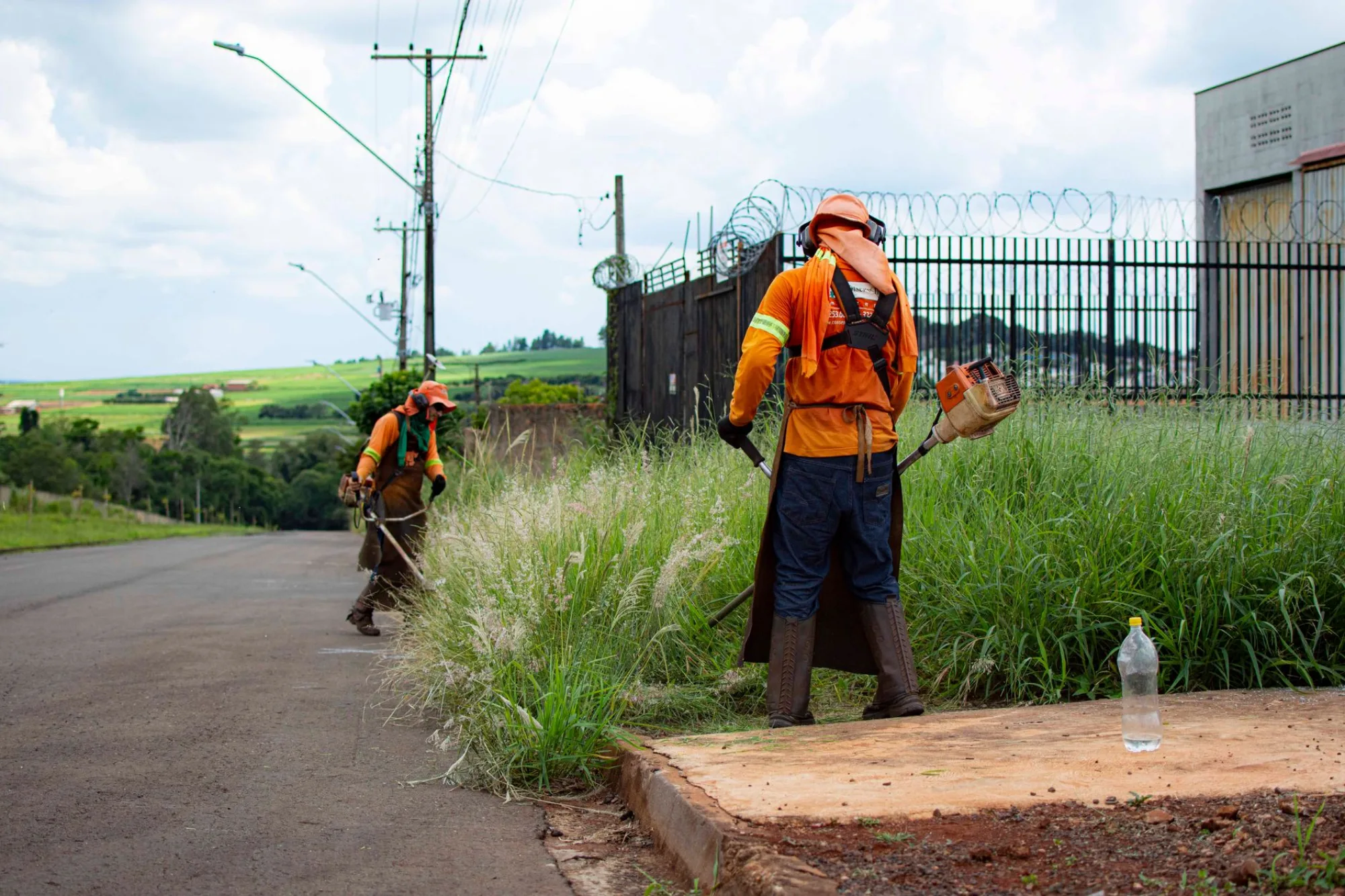 Flash Landscaping crew trimming grass along a property edge