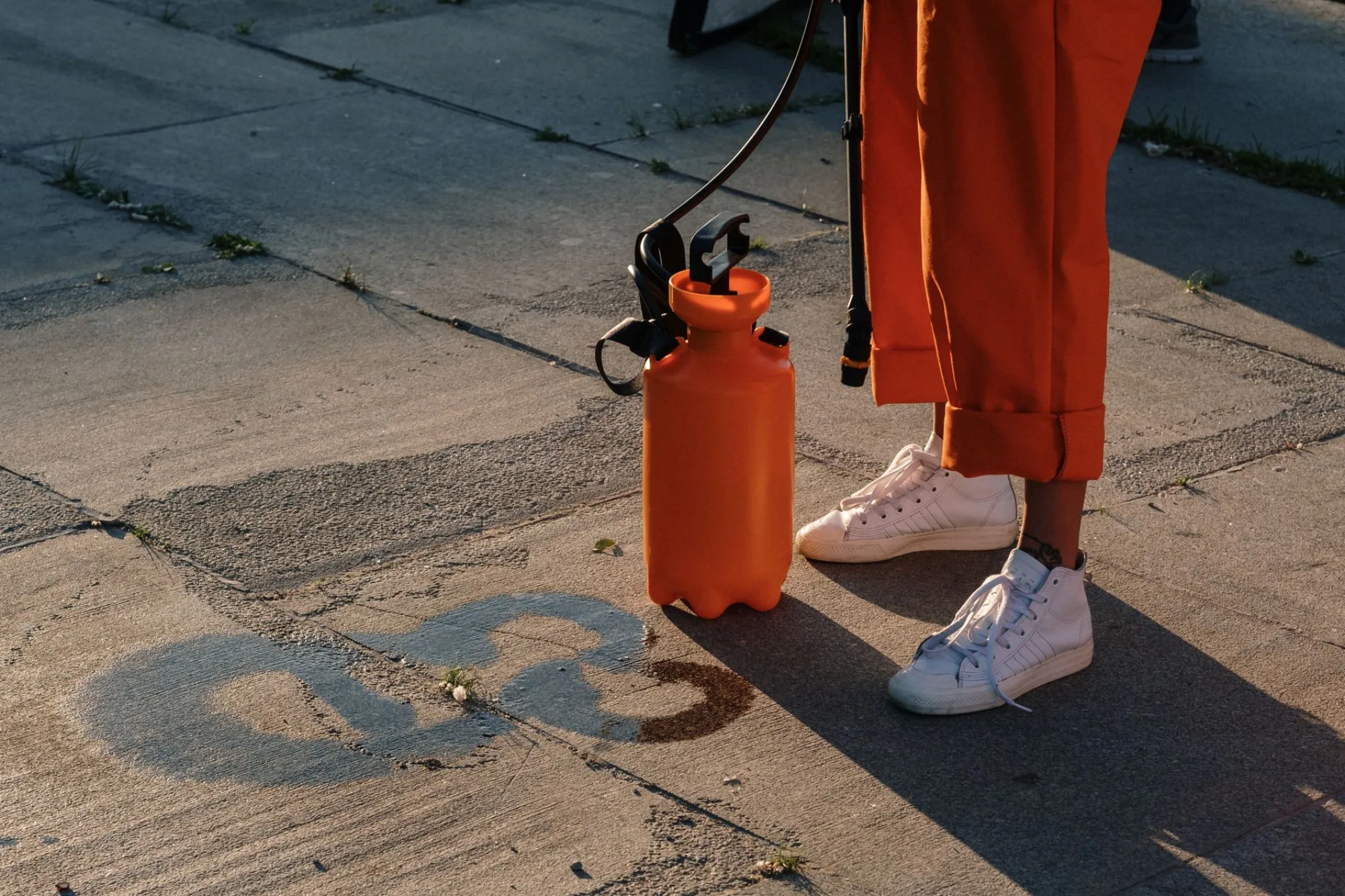 Pressure washing crew with equipment on a concrete driveway in the Atlanta evening light