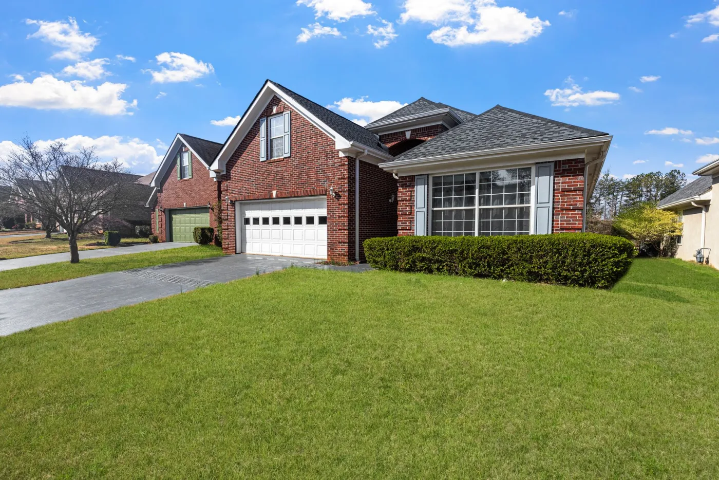 A clean house driveway after pressure washing by LC Solutions