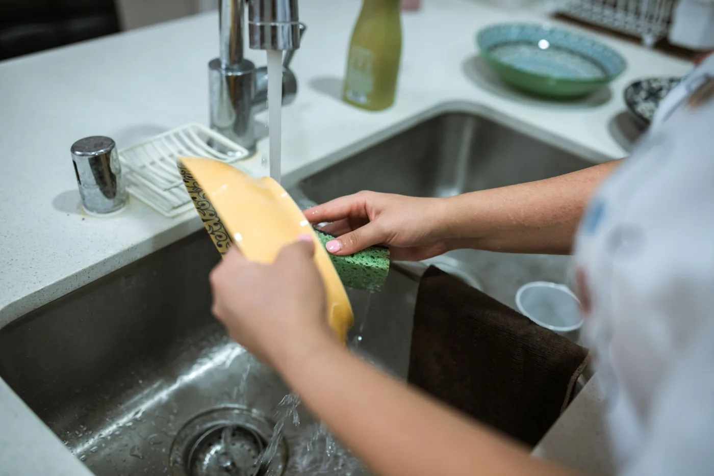 A sponge cleaning a sink up close