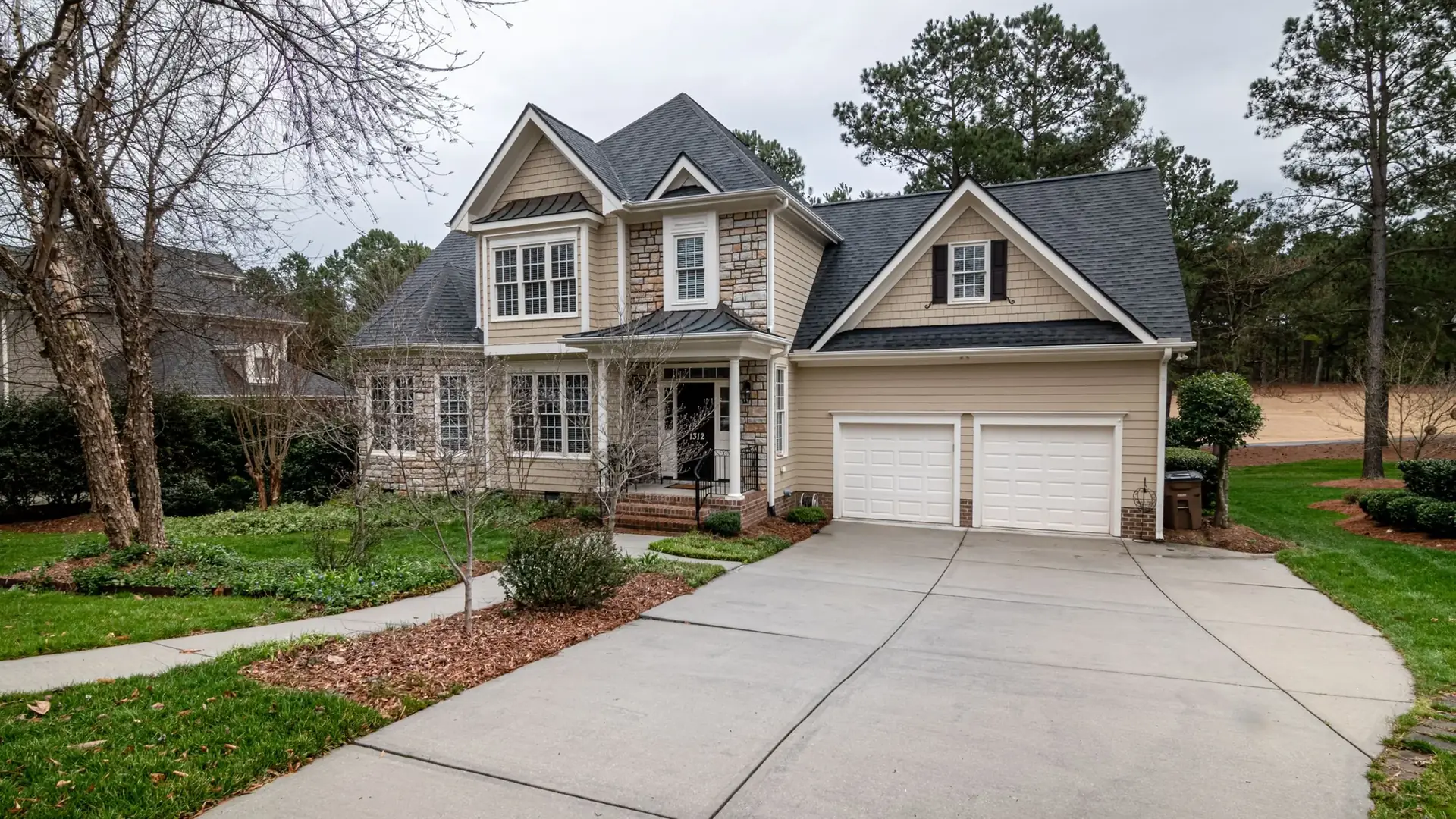 Freshly mowed Charlotte lawn with clean mower stripes and a sharp edge along the front walkway