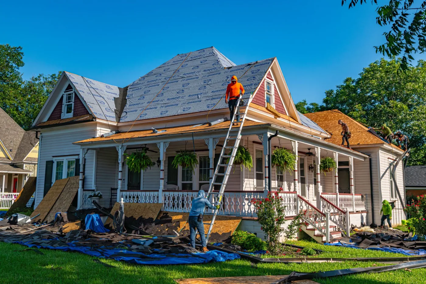 Roofer working on a newly shingled roof slope