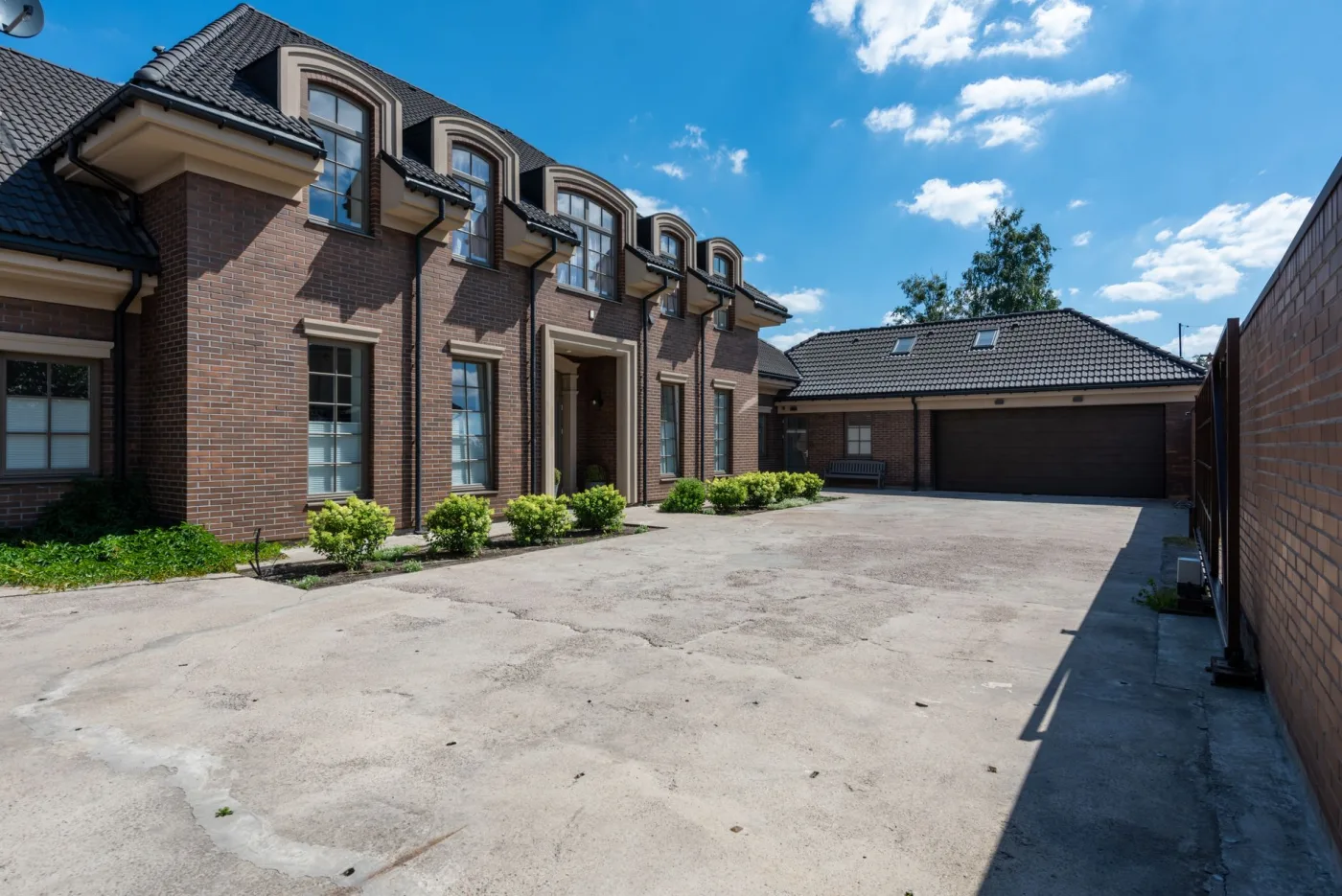 Clean townhome driveways side by side after pressure washing