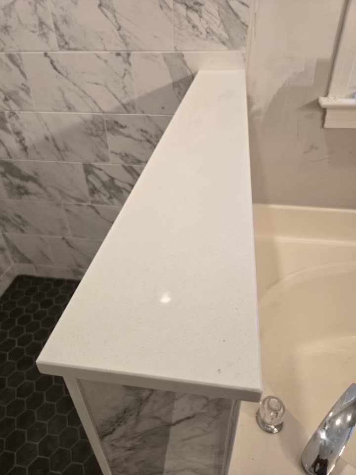 The quartz cap on the shower curb, cut and set.