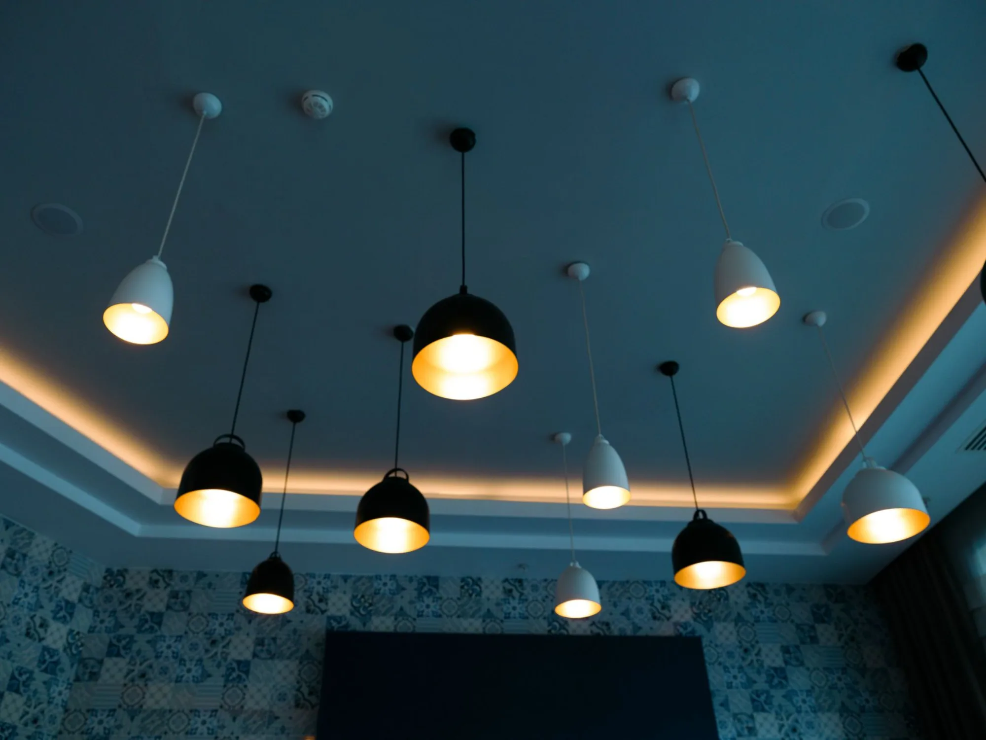 Warm modern living room with recessed ceiling lighting and pendant fixtures installed by SmartWire Solutions