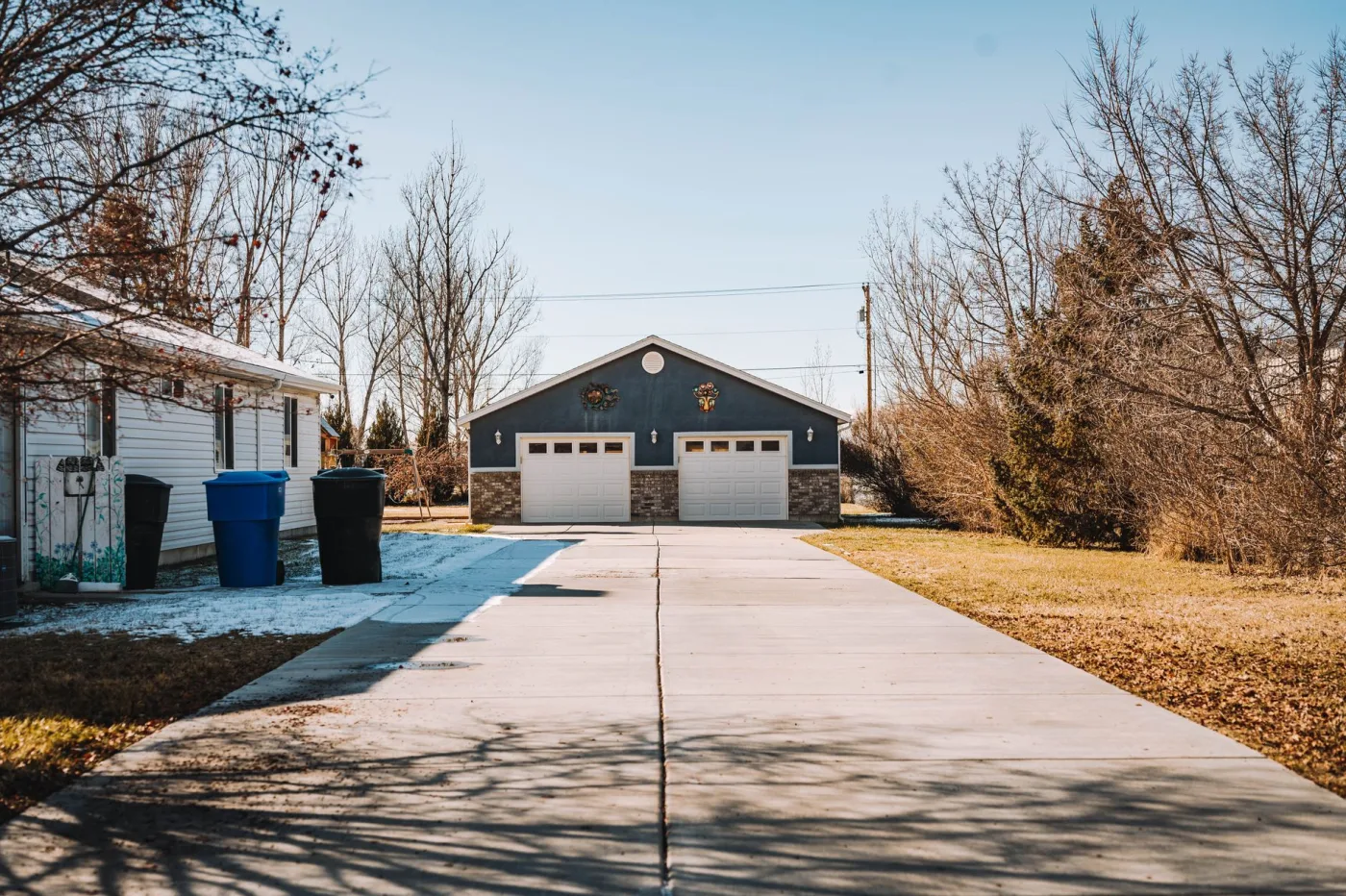 A concrete driveway washed to an even, clean finish leading up to a garage